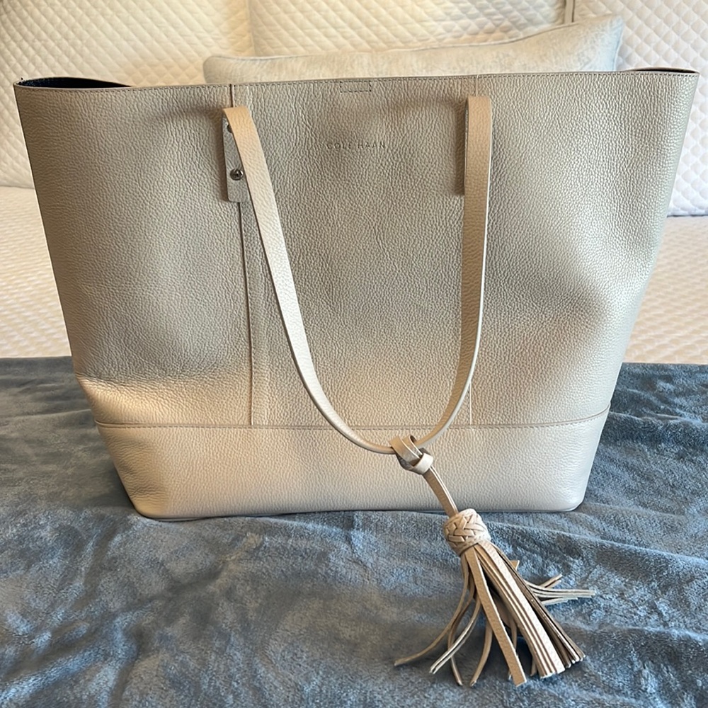 Large Cole Haan bone/cream pebbled tote bag with tassel used once